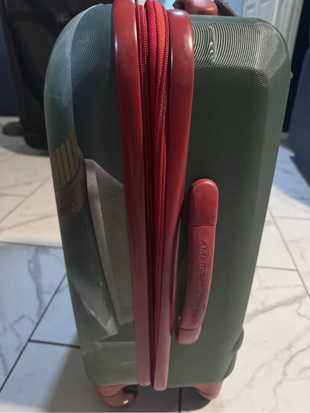 Green Hardshell Carry-On with red Accents